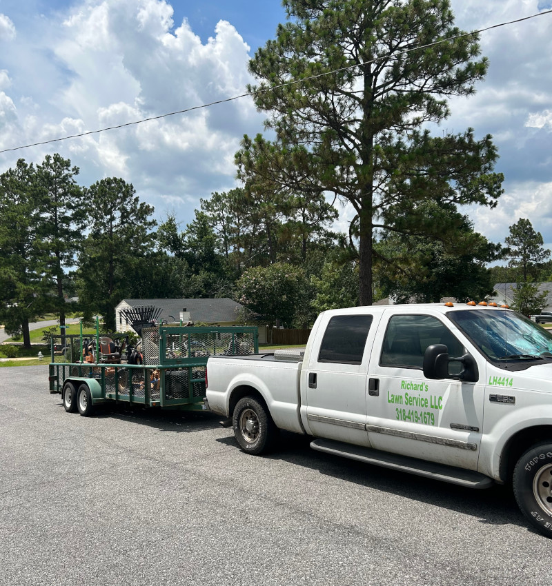 Outdoor Services Crew Truck with lawn equipment and trailer.